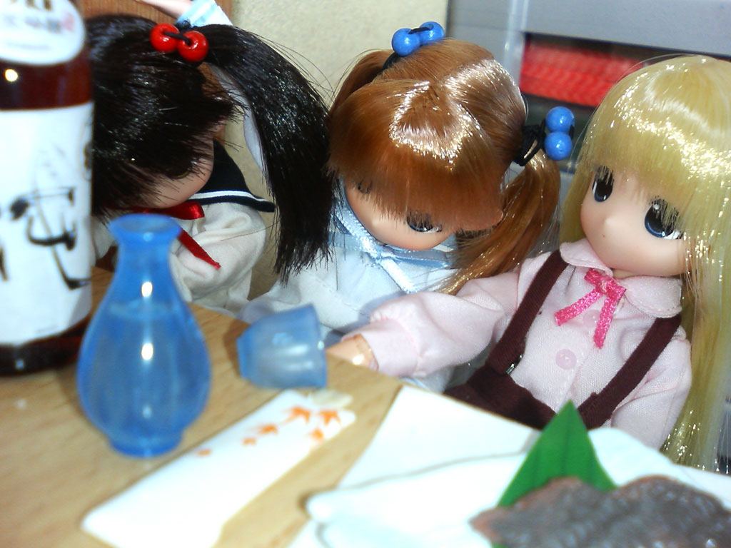 photo (medium), 3girls, black hair, blonde hair, blue eyes, bow, doll, female focus, glass, hair bobbles, hair ornament, multiple girls, orange hair, overalls, pink shirt, school uniform, serafuku, shirt, table, toy, twintails