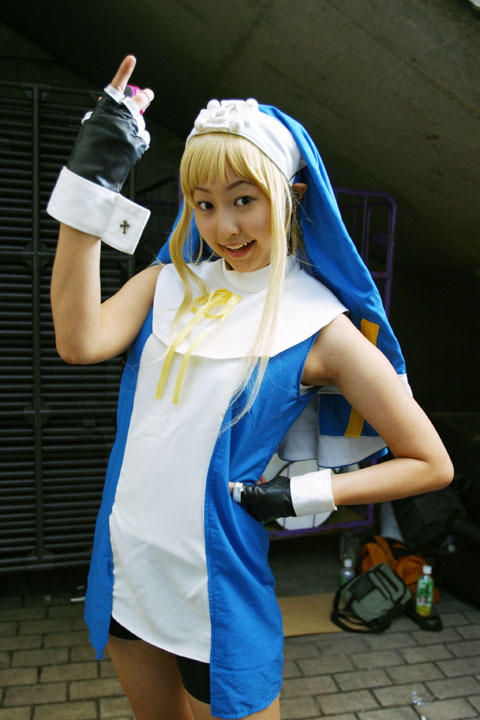 bridget (guilty gear), arc system works, guilty gear, cosplay photo, photo (medium), 1boy, cosplay, crossdressing, crossdressing (mtf), male focus, solo, standing