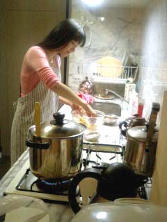 tanaka rie, lowres, photo (medium), 1girl, apron, cooking, female focus, kitchen, qvga, solo, striped apron, striped clothes