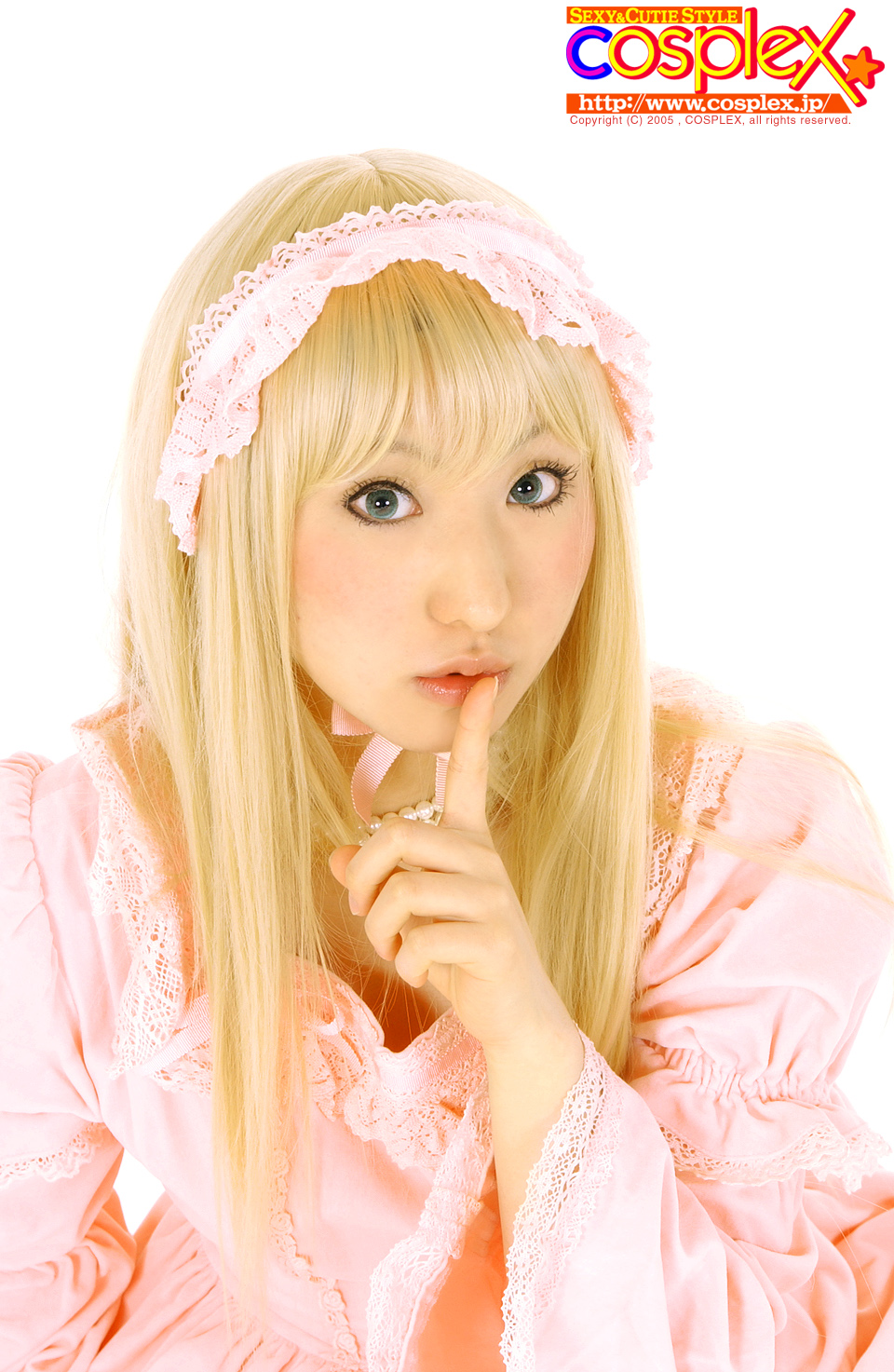 cosplex, real life, cosplay photo, highres, off-topic, photo (medium), 1girl, blonde hair, bonnet, choker, cosplay, dress, female focus, finger to mouth, frilled dress, frills, green eyes, jewelry, lips, long hair, looking at viewer, maid headdress, necklace, parted lips, pink dress, puffy sleeves, ribbon, shushing, simple background, solo, white background