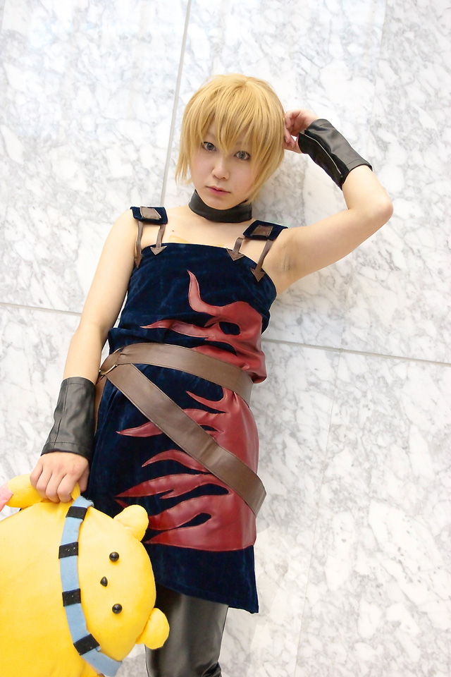 cosplay photo, photo (medium), 1girl, belt, blonde hair, collar, cosplay, dress, female focus, short hair, solo, stuffed animal, stuffed toy, wristband