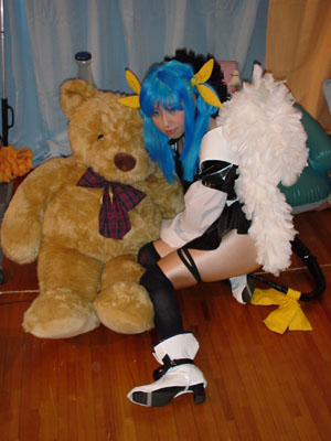 dizzy (guilty gear), arc system works, guilty gear, cosplay photo, lowres, photo (medium), 1girl, asymmetrical wings, blue hair, cosplay, female focus, pantyhose, ribbon, solo, tail, tail ornament, tail ribbon, wings