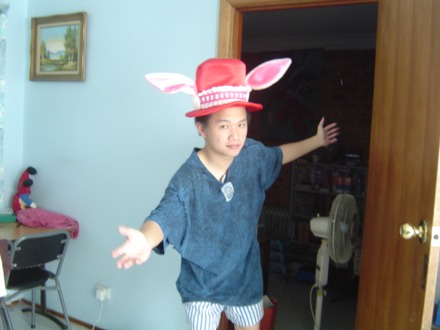 meroko, meroko yui, roobar, full moon wo sagashite, cosplay photo, photo (medium), animal ears, cosplay, electric fan, hat, rabbit ears, red hat, shorts, solo, striped clothes, striped shorts, vertical-striped clothes, vertical-striped shorts
