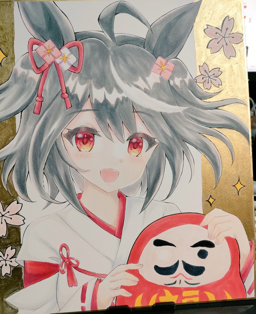 terimuku, kitasan black (umamusume), umamusume, commentary request, photo (medium), traditional media, 1girl, :d, ahoge, animal ears, black hair, daruma doll, hair ornament, horse ears, japanese clothes, kimono, long sleeves, looking at viewer, multicolored hair, open mouth, red eyes, ribbon-trimmed sleeves, ribbon trim, shikishi, sleeves past wrists, smile, solo, streaked hair, two side up, upper body, white hair, white kimono, wide sleeves