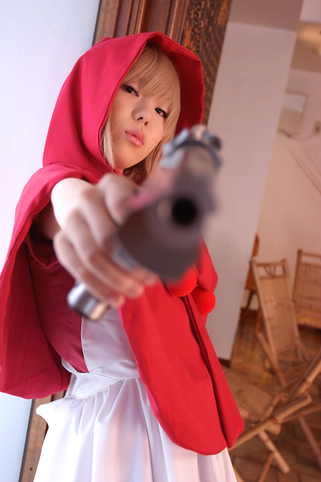 b.b. hood, capcom, darkstalkers, cosplay photo, photo (medium), 1girl, aiming, aiming at viewer, cosplay, desert eagle, female focus, gun, handgun, holding, holding gun, holding weapon, hood, pistol, solo, weapon