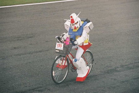gundam, framed, lowres, photo (medium), backpack, bag, bicycle, cosplay, grass, racing, randoseru, road, stuffed animal, stuffed toy, what, wheel