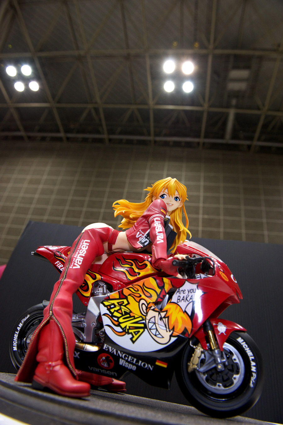 souryuu asuka langley, neon genesis evangelion, wonder festival, wonder festival 2008, vehicle, highres, photo (medium), 1girl, ass cutout, blue eyes, boots, chaps, clothing cutout, female focus, figure, jacket, leather, leather clothes, leather pants, motor vehicle, motorcycle, pants, smile, solo, zipper