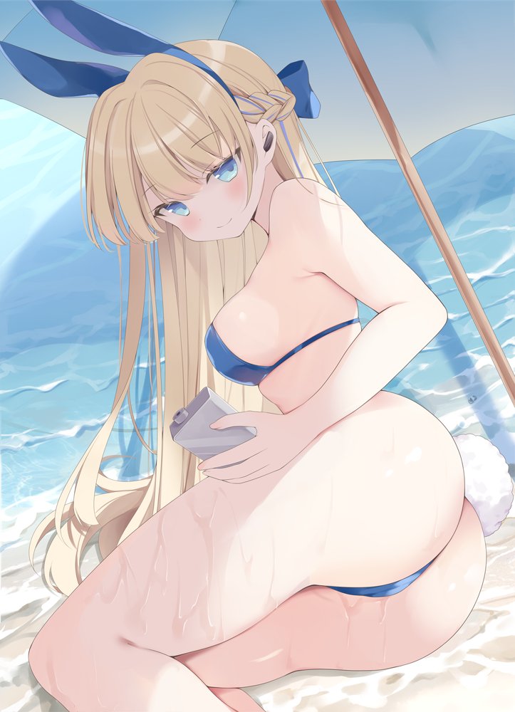 hoshino koucha, toki (blue archive), toki (bunny) (blue archive), blue archive, 1girl, animal ears, ass, beach, blonde hair, blue eyes, blue halo, bow, breasts, fake animal ears, halo, long hair, looking at viewer, lotion, lotion bottle, lying, on side, outdoors, parasol, rabbit ears, solo, strapless, thighs, umbrella