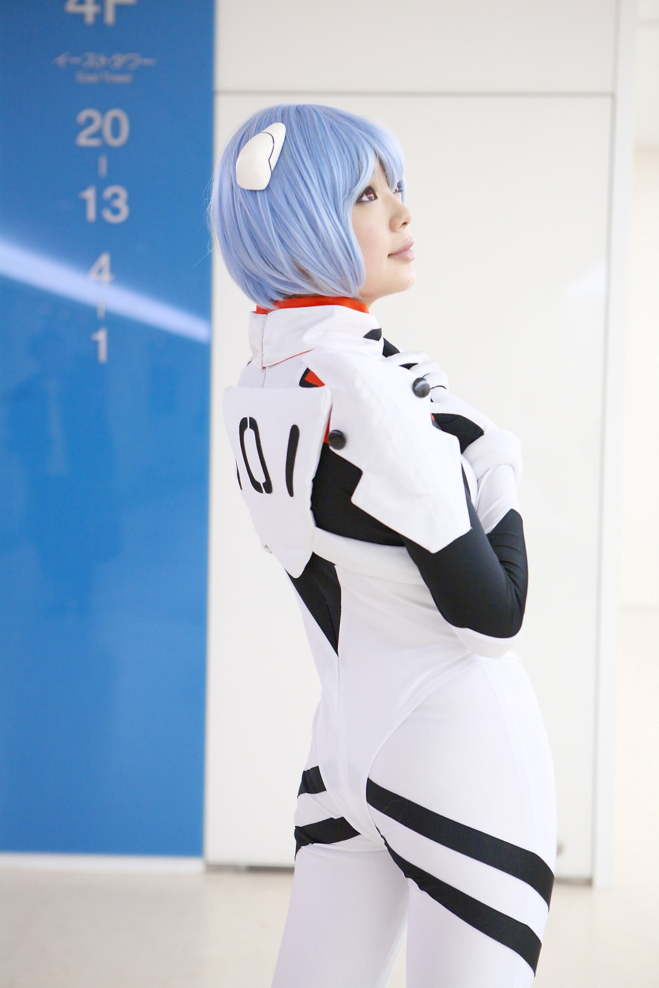 namada, ayanami rei, neon genesis evangelion, highres, photo (medium), 1girl, asian, blue hair, color contacts, cosplay, cowboy shot, female focus, hairpods, looking up, mecha pilot suit, parted lips, plugsuit (evangelion), red eyes, short hair, solo, standing