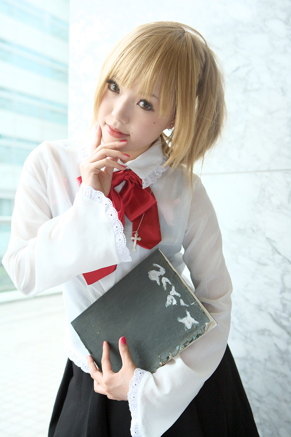 kipi-san, amane misa, death note, highres, photo (medium), 1girl, amane misa (cosplay), asian, blonde hair, breasts, color contacts, cosplay, cross, cross necklace, death note (object), female focus, indoors, jewelry, looking at viewer, mole, necklace, skirt, small breasts, solo