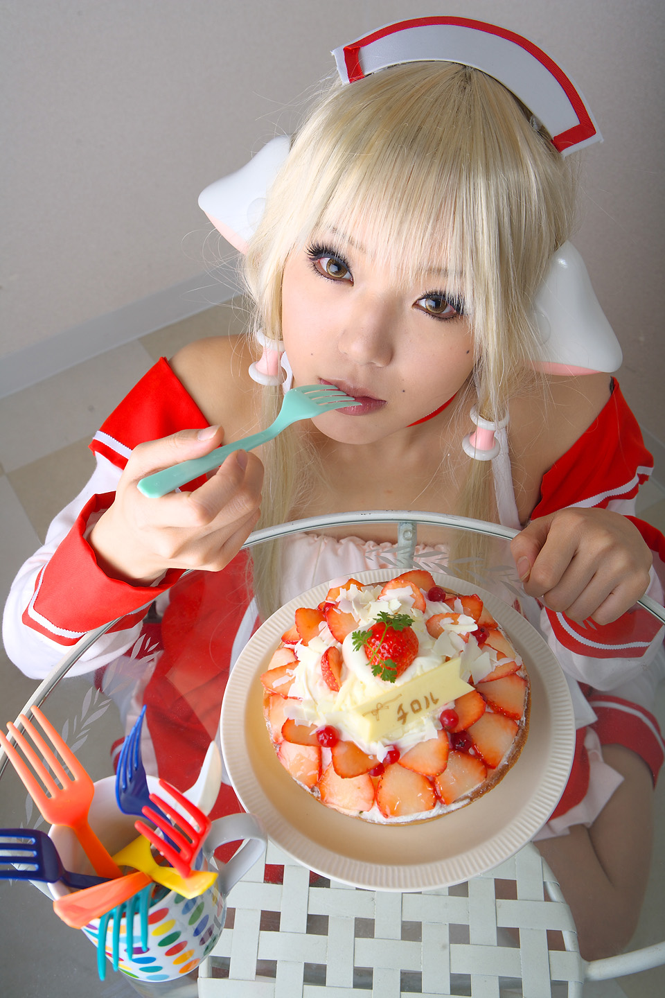 kipi-san, chii, chobits, highres, photo (medium), 1girl, apron, asian, blonde hair, cake, chii (cosplay), cosplay, female focus, food, indoors, long hair, looking at viewer, persocom, solo, strawberry shortcake, waitress, waitress uniform