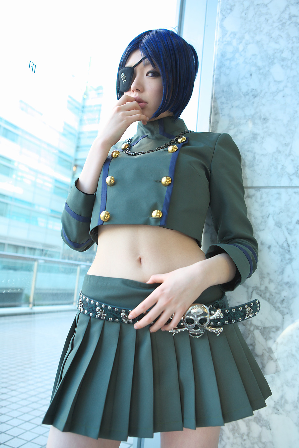 namada, chrome dokuro, katekyo hitman reborn!, highres, photo (medium), 1girl, asian, blue hair, blurry, breasts, color contacts, cosplay, cowboy shot, depth of field, eyepatch, female focus, indoors, looking at viewer, makeup, mascara, midriff, miniskirt, navel, parted lips, pleated skirt, short hair, skirt, skull and crossbones, skull belt, small breasts, solo, standing, window