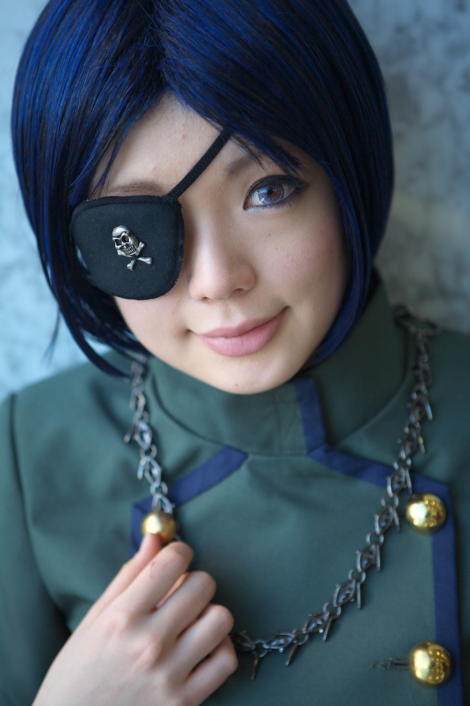 namada, chrome dokuro, katekyo hitman reborn!, highres, photo (medium), 1girl, asian, blue hair, blurry, color contacts, cosplay, depth of field, eyepatch, female focus, jewelry, looking at viewer, makeup, mascara, necklace, short hair, skull and crossbones, smile, solo