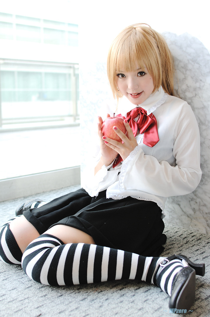kipi-san, amane misa, death note, photo (medium), 1girl, amane misa (cosplay), apple, asian, blonde hair, breasts, cosplay, cross, cross necklace, female focus, food, fruit, indoors, jewelry, looking at viewer, miniskirt, mole, nail polish, necklace, sitting, skirt, small breasts, solo, striped clothes, striped thighhighs, thighhighs, wariza