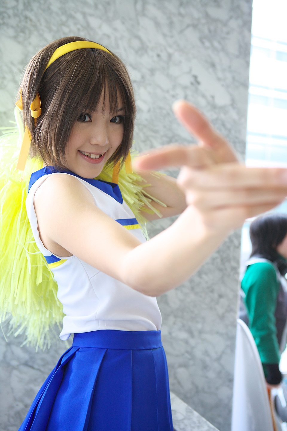kipi-san, suzumiya haruhi, suzumiya haruhi no yuuutsu, highres, photo (medium), 1girl, asian, brown eyes, brown hair, cheerleader, cosplay, female focus, looking at viewer, mole, pom pom (cheerleading), short hair, smile, solo, suzumiya haruhi (cosplay)