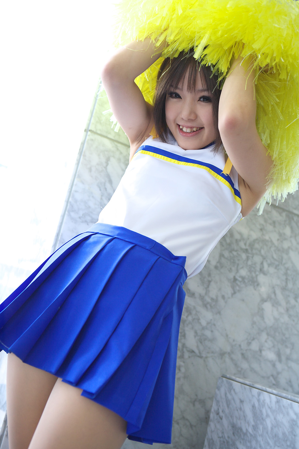kipi-san, suzumiya haruhi, suzumiya haruhi no yuuutsu, highres, photo (medium), 1girl, asian, brown eyes, brown hair, cheerleader, cosplay, dutch angle, female focus, looking at viewer, mole, pom pom (cheerleading), smile, solo, suzumiya haruhi (cosplay)