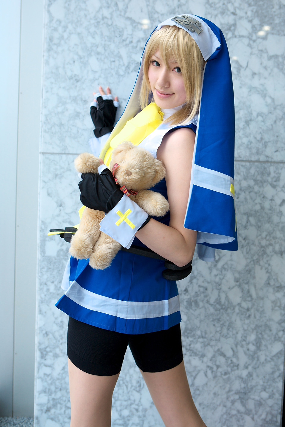 saya (cosplayer), bridget (guilty gear), arc system works, guilty gear, highres, photo (medium), blonde hair, cosplay, cross, solo, teddy bear