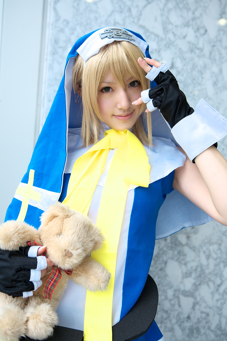 saya (cosplayer), bridget (guilty gear), arc system works, guilty gear, highres, photo (medium), blonde hair, cosplay, cross, solo, teddy bear