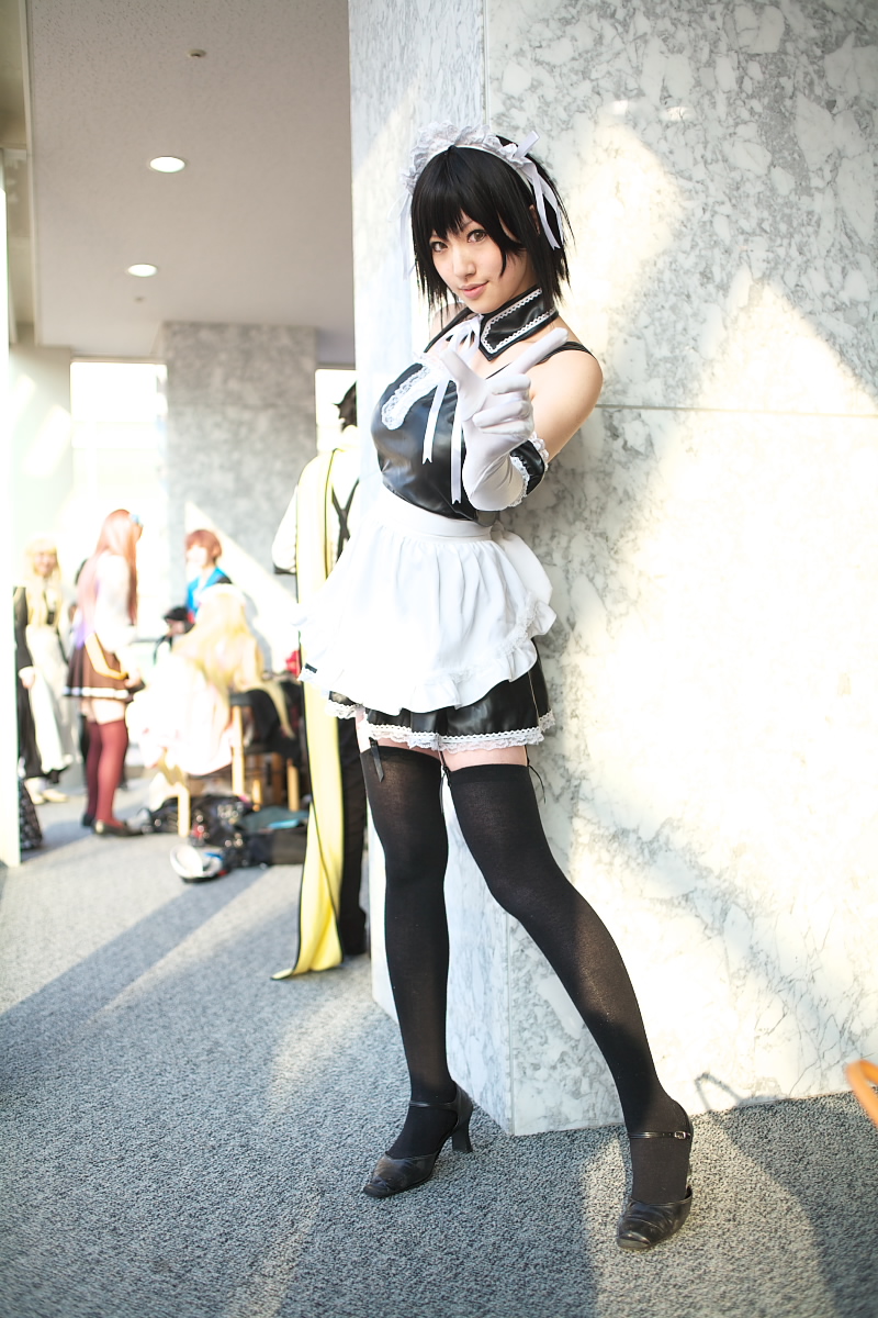 saya (cosplayer), sawatari izumi, kore ga watashi no goshujin-sama, black footwear, highres, photo (medium), 1girl, apron, asian, bare shoulders, black hair, black thighhighs, blurry, cosplay, depth of field, detached collar, elbow gloves, facing viewer, full body, garter straps, gloves, japanese (nationality), looking at viewer, maid, maid apron, maid headdress, nakabayashi yoshitaka's maid uniform, sawatari izumi (cosplay), short hair, solo focus, standing, thighhighs, waist apron, white apron, white gloves, zettai ryouiki
