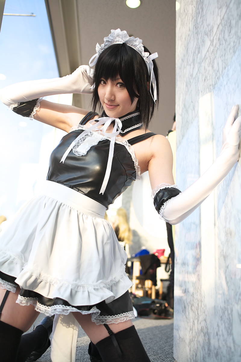 saya (cosplayer), sawatari izumi, kore ga watashi no goshujin-sama, black footwear, highres, photo (medium), 1girl, apron, asian, bare shoulders, black hair, black thighhighs, blurry, cosplay, depth of field, detached collar, elbow gloves, facing viewer, garter straps, gloves, japanese (nationality), kneeling, looking at viewer, maid, maid apron, maid headdress, multiple girls, nakabayashi yoshitaka's maid uniform, sawatari izumi (cosplay), short hair, sitting, solo focus, thighhighs, waist apron, white apron, white gloves, zettai ryouiki