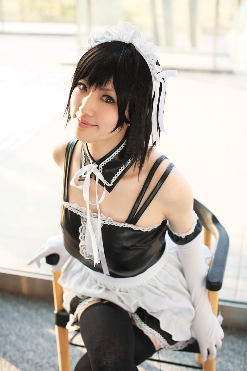 saya (cosplayer), sawatari izumi, kore ga watashi no goshujin-sama, black footwear, highres, photo (medium), 1girl, apron, asian, bare shoulders, black hair, black thighhighs, blurry, chair, cosplay, crossed legs, day, depth of field, detached collar, elbow gloves, facing viewer, feet out of frame, female focus, garter straps, gloves, japanese (nationality), looking at viewer, maid, maid apron, maid headdress, nakabayashi yoshitaka's maid uniform, sawatari izumi (cosplay), short hair, sitting, solo, thighhighs, waist apron, white apron, white gloves, window