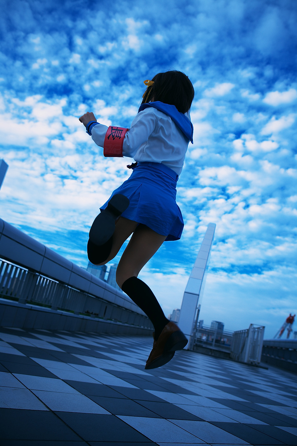 kipi-san, suzumiya haruhi, suzumiya haruhi no yuuutsu, highres, photo (medium), 1girl, armband, asian, cloud, cosplay, dutch angle, female focus, jumping, outdoors, school uniform, sky, solo, suzumiya haruhi (cosplay)