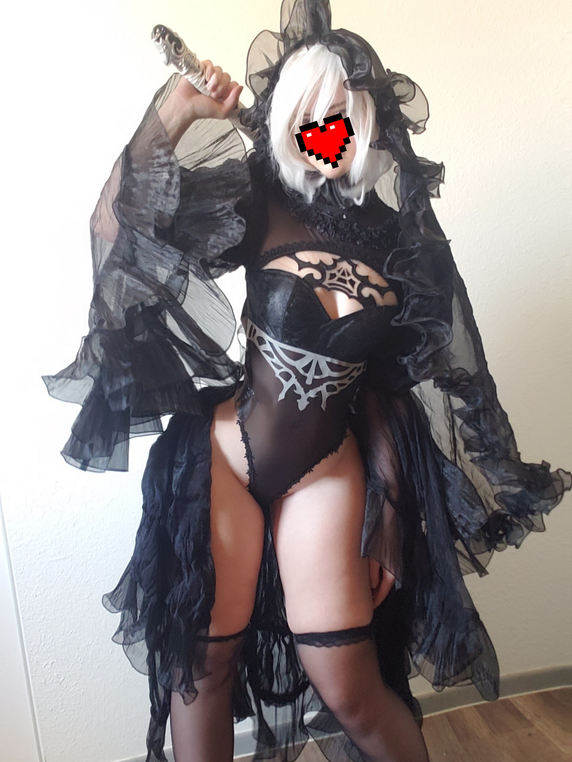 unkyndled, 2b (nier:automata), nier:automata, nier (series), real life, 1girl, 2b (nier:automata) (cosplay), black gloves, black hairband, black leotard, black thighhighs, breasts, bridal veil, cleavage, cosplay, covered navel, elbow gloves, frilled leotard, frills, gloves, hairband, highleg, highleg leotard, holding, holding sword, holding weapon, katana, leotard, narrow waist, phone, revealing clothes, short hair, sword, thighhighs, thong leotard, veil, weapon, white hair