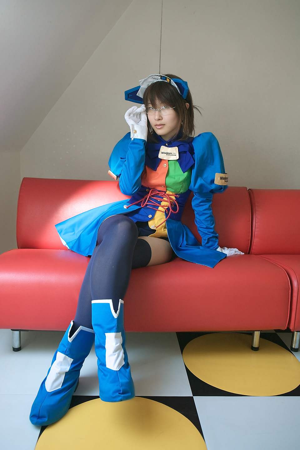 2k-tan, os-tan, highres, photo (medium), cosplay, couch, glasses, gloves, pantyhose, red upholstery, sitting, solo, thighhighs, white gloves