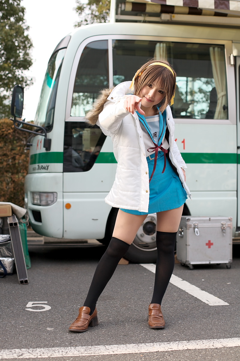 kipi-san, suzumiya haruhi, suzumiya haruhi no yuuutsu, highres, photo (medium), 1girl, asian, brown eyes, brown hair, bus, cosplay, female focus, looking at viewer, motor vehicle, outdoors, school uniform, smile, solo, suzumiya haruhi (cosplay)