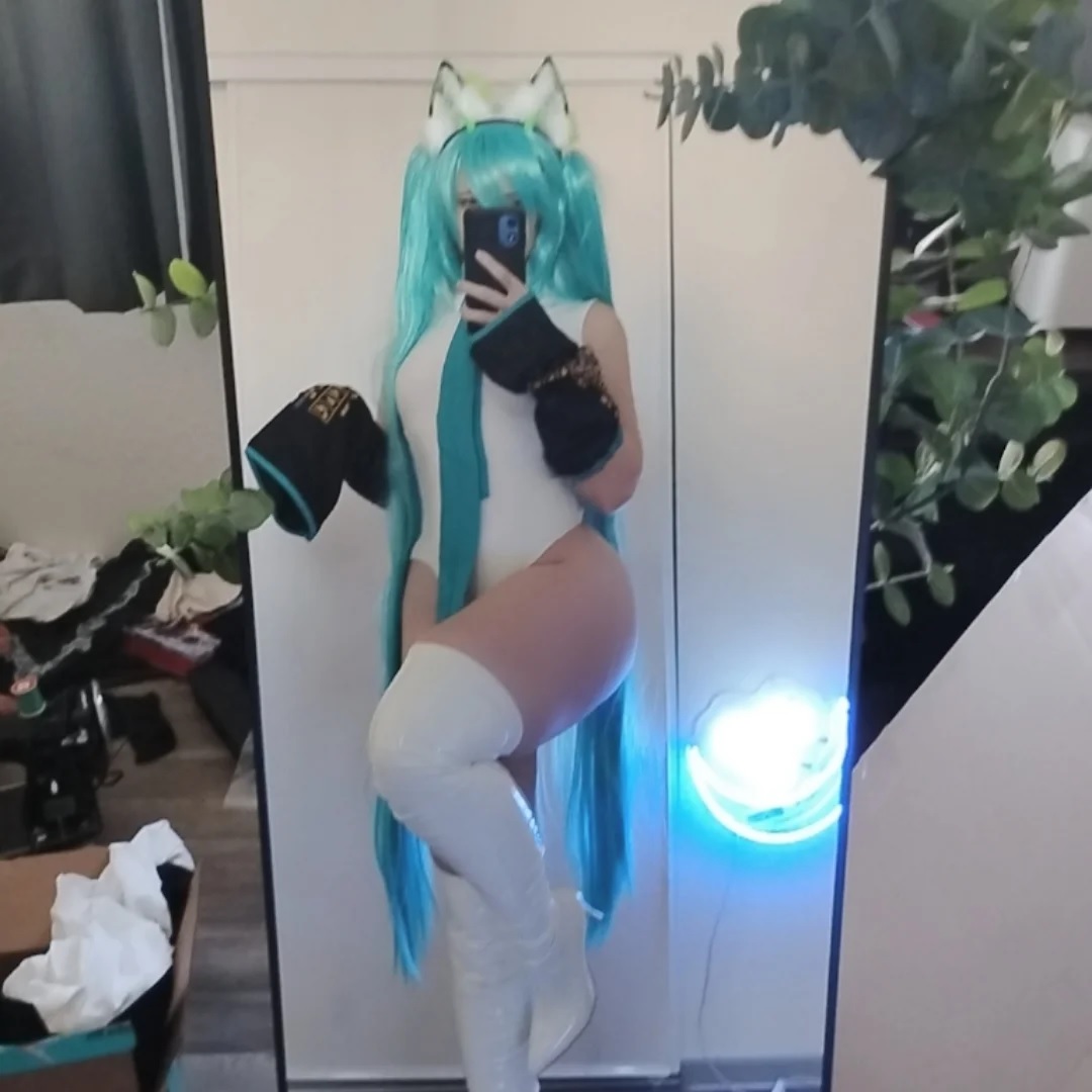 unkyndled, hatsune miku, real life, vocaloid, photo (medium), 1girl, blur censor, breasts, censored, cleavage, cosplay, green hair, hair over one eye, hatsune miku (cosplay), holding, holding phone, indoors, leotard, lips, long hair, long sleeves, long twintails, looking at viewer, narrow waist, parted lips, phone, revealing clothes, selfie, smile, twintails, very long hair, white leotard, wide hips