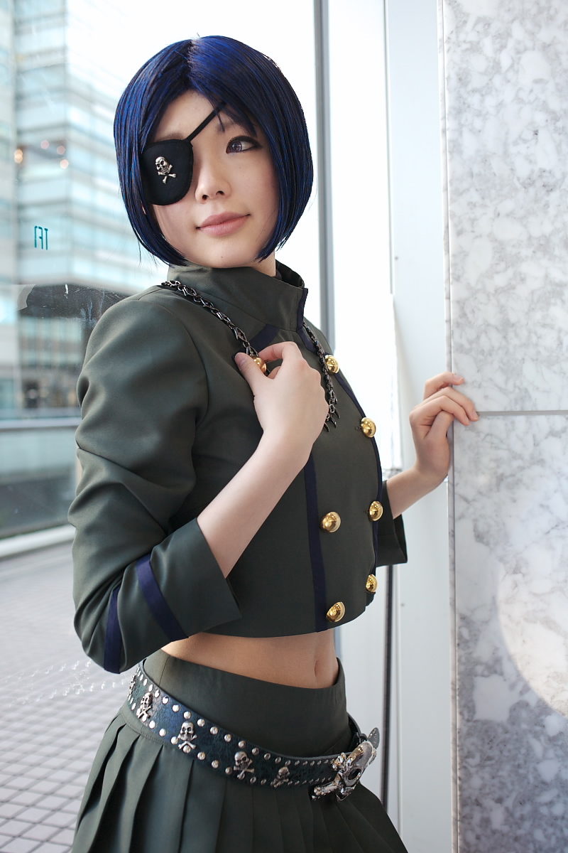 namada, chrome dokuro, katekyo hitman reborn!, highres, photo (medium), 1girl, asian, belt, blue hair, blurry, breasts, color contacts, cosplay, depth of field, eyepatch, female focus, indoors, jewelry, looking to the side, makeup, mascara, midriff, navel, necklace, parted lips, pleated skirt, short hair, skirt, skull and crossbones, skull belt, small breasts, solo, standing, window
