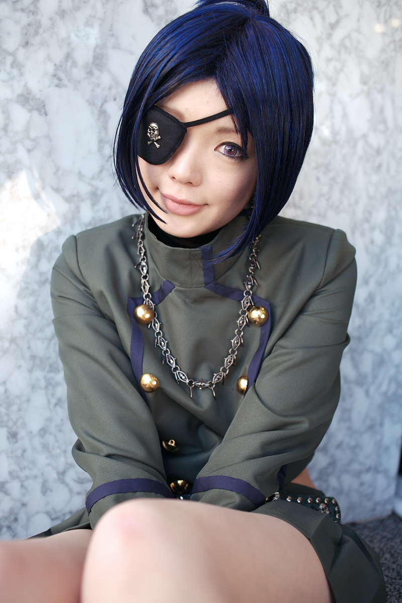 namada, chrome dokuro, kateikyoushi hitman reborn, katekyo hitman reborn!, highres, photo (medium), 1girl, asian, blue hair, breasts, color contacts, cosplay, eyepatch, female focus, head tilt, light smile, looking at viewer, makeup, mascara, miniskirt, on floor, pleated skirt, rug, short hair, sitting, skirt, skull and crossbones, skull belt, small breasts, solo, v arms