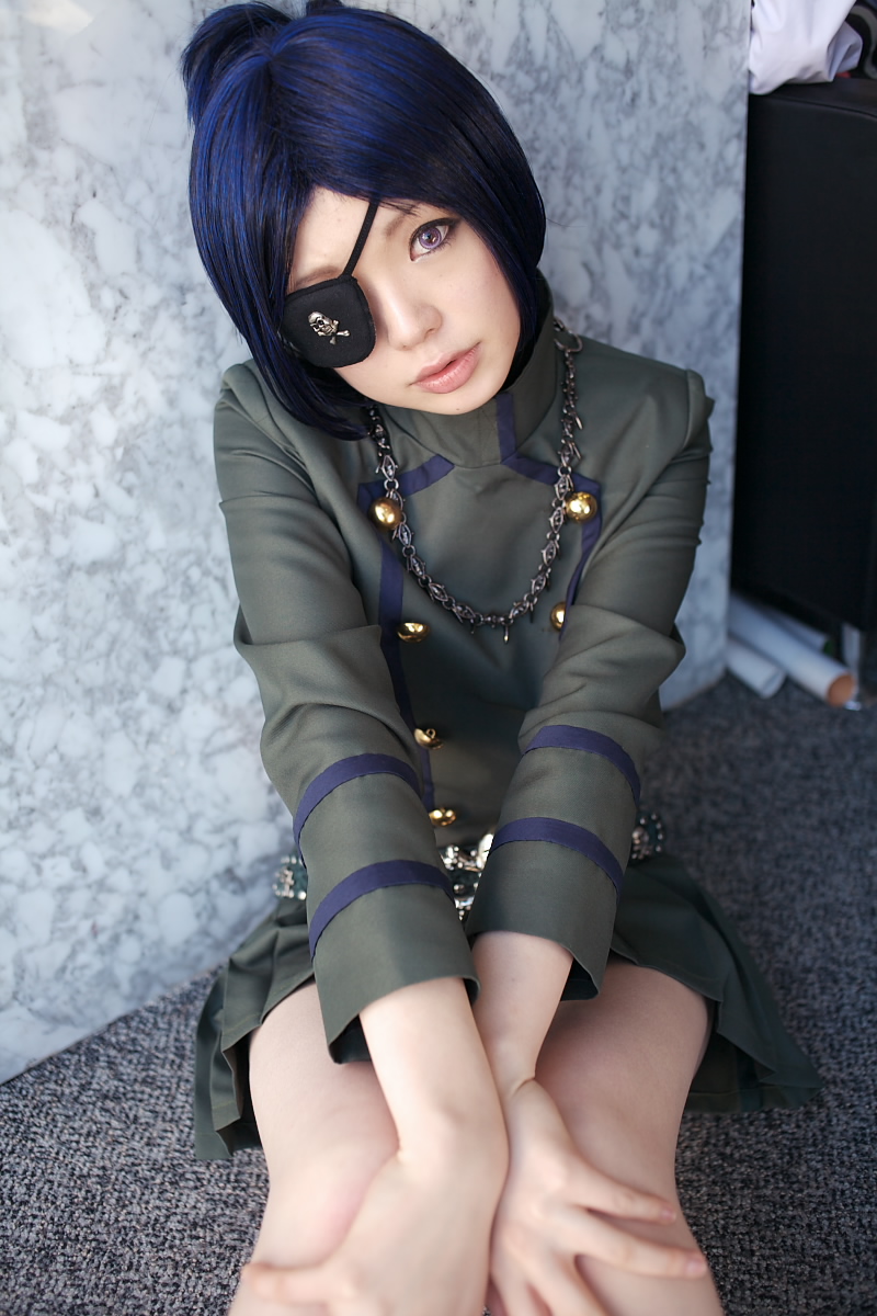 namada, chrome dokuro, kateikyoushi hitman reborn, katekyo hitman reborn!, highres, photo (medium), 1girl, asian, blue hair, breasts, color contacts, cosplay, eyepatch, female focus, head tilt, looking at viewer, makeup, mascara, miniskirt, on floor, pleated skirt, rug, short hair, sitting, skirt, skull and crossbones, skull belt, small breasts, solo, v arms