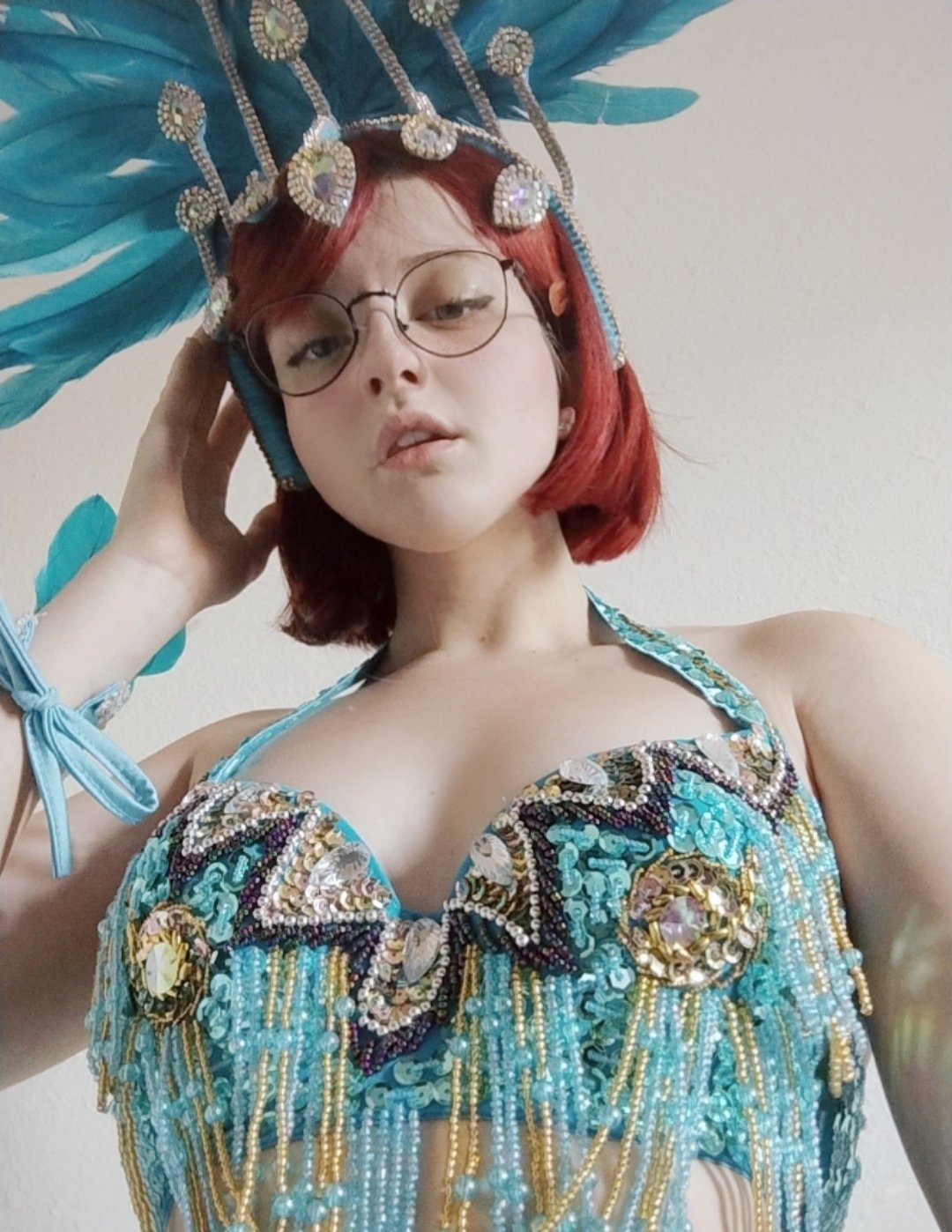 unkyndled, linda gunderson, rio (movie), 1girl, black hair, bob cut, breasts, carnival, cleavage, dancing, from below, fur-trimmed skirt, fur trim, glasses, linda gunderson (cosplay), looking at viewer, parted lips, red hair, revealing clothes, short hair, skirt