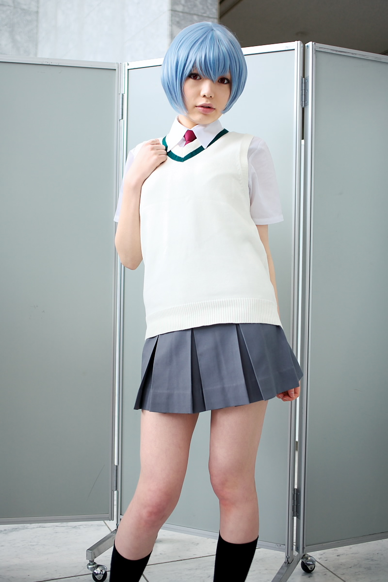 namada, ayanami rei, neon genesis evangelion, highres, photo (medium), 1girl, alternate costume, asian, black socks, blue hair, breasts, color contacts, contrapposto, cosplay, female focus, grey skirt, indoors, looking at viewer, miniskirt, necktie, parted lips, pleated skirt, red eyes, red necktie, school uniform, shirt, short hair, short sleeves, skirt, small breasts, socks, solo, standing, sweater vest, white shirt