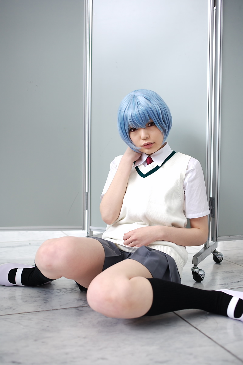 namada, ayanami rei, neon genesis evangelion, highres, photo (medium), 1girl, alternate costume, asian, black socks, blue hair, breasts, color contacts, cosplay, female focus, grey skirt, indoors, looking at viewer, miniskirt, necktie, on floor, pleated skirt, red eyes, red necktie, school uniform, shirt, shoes, short hair, short sleeves, sitting, skirt, small breasts, socks, solo, sweater vest, uwabaki, white shirt, white shoes