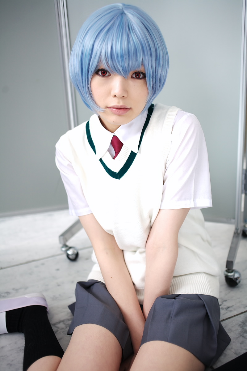 namada, ayanami rei, neon genesis evangelion, highres, photo (medium), 1girl, alternate costume, asian, black socks, blue hair, breasts, color contacts, cosplay, female focus, grey skirt, indoors, looking at viewer, miniskirt, necktie, on floor, pleated skirt, red eyes, red necktie, school uniform, shirt, shoes, short hair, short sleeves, sitting, skirt, small breasts, socks, solo, sweater vest, uwabaki, wariza, white shirt, white shoes