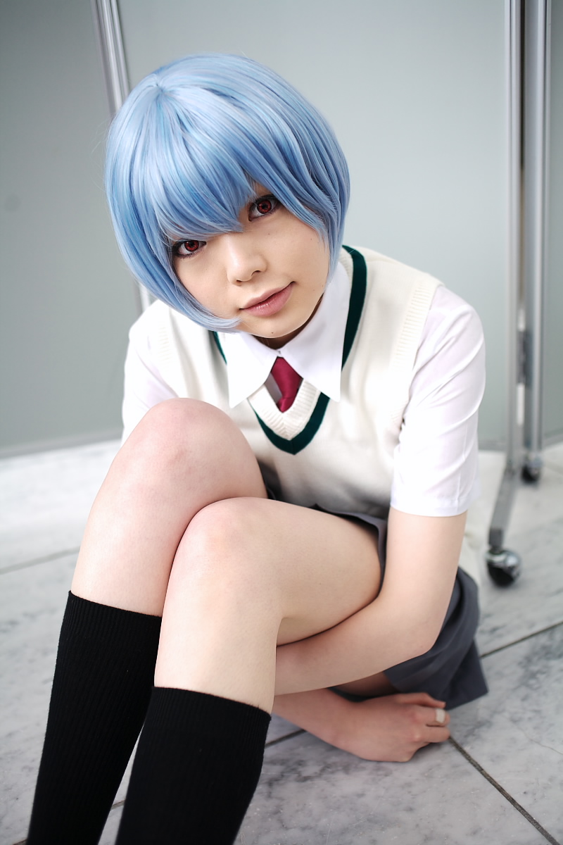 namada, ayanami rei, neon genesis evangelion, highres, photo (medium), 1girl, alternate costume, asian, black socks, blue hair, breasts, color contacts, cosplay, female focus, grey skirt, hugging own legs, indoors, looking at viewer, miniskirt, necktie, on floor, pleated skirt, red eyes, red necktie, school uniform, shirt, shoes, short hair, short sleeves, sitting, skirt, small breasts, socks, solo, sweater vest, uwabaki, white shirt, white shoes
