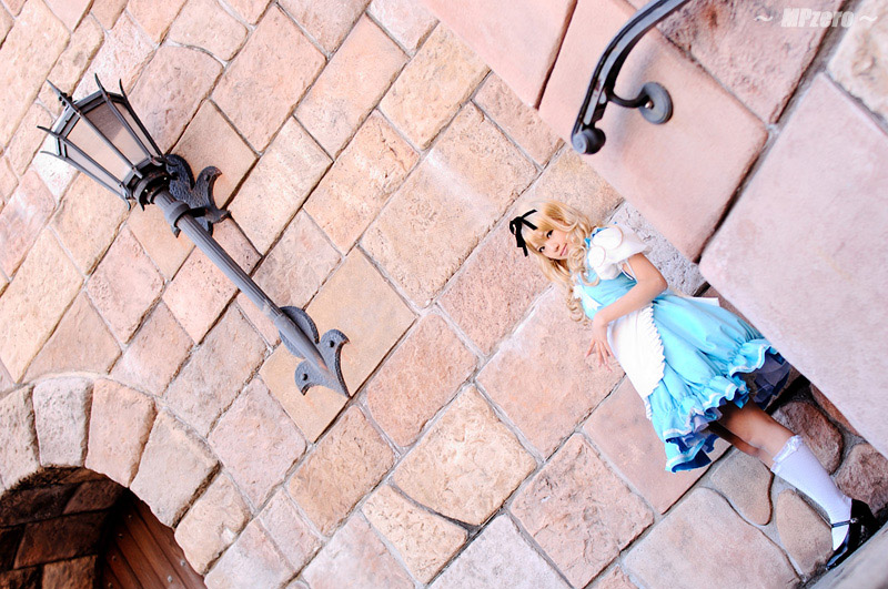 kipi-san, alice (alice in wonderland), alice's adventures in wonderland, photo (medium), 1girl, alice (alice in wonderland) (cosplay), asian, breasts, cosplay, dutch angle, female focus, long hair, looking at viewer, outdoors, petite, small breasts, solo