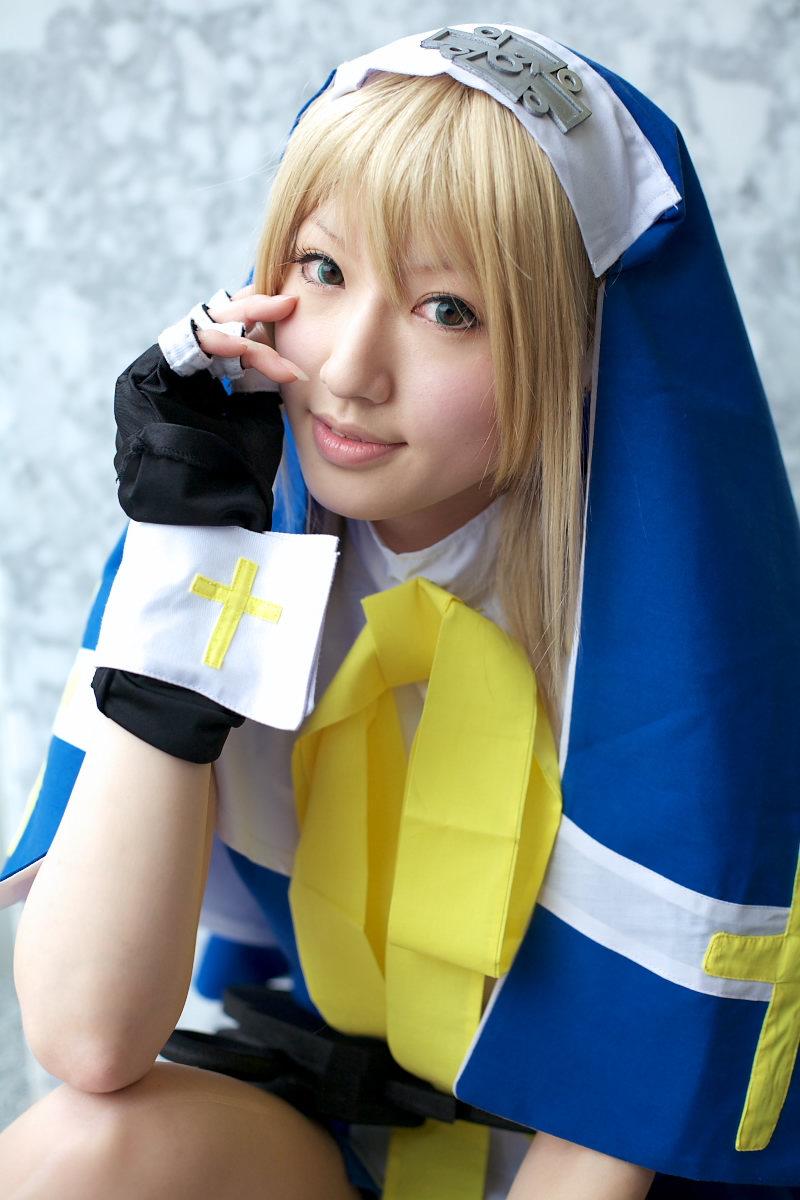 saya (cosplayer), bridget (guilty gear), arc system works, guilty gear, highres, photo (medium), blonde hair, cosplay, cross, fingerless gloves, gloves, solo, symbol
