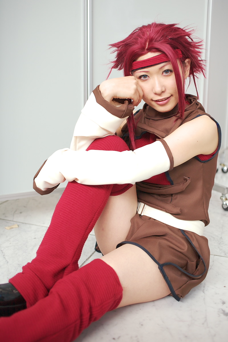 chippi, kouzuki kallen, code geass, highres, photo (medium), 1girl, asian, blue eyes, color contacts, cosplay, female focus, kouzuki kallen (cosplay), looking at viewer, red hair, short hair, sitting, solo