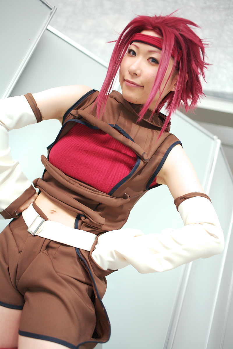 chippi, kouzuki kallen, code geass, highres, photo (medium), 1girl, asian, blue eyes, color contacts, cosplay, dutch angle, female focus, indoors, kouzuki kallen (cosplay), looking at viewer, midriff, red hair, short hair, solo
