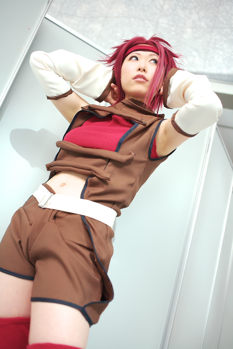 chippi, kouzuki kallen, code geass, highres, photo (medium), 1girl, asian, blue eyes, color contacts, cosplay, dutch angle, female focus, indoors, kouzuki kallen (cosplay), midriff, red hair, short hair, solo