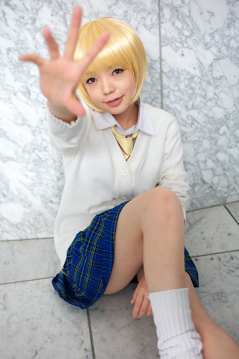 namada, nishino tsukasa, ichigo 100%, highres, photo (medium), 1girl, asian, blonde hair, blouse, blurry, bob cut, breasts, cardigan, cosplay, depth of field, female focus, indoors, light smile, looking at viewer, loose socks, miniskirt, necktie, on floor, outstretched arm, parted lips, plaid clothes, plaid skirt, pleated skirt, school uniform, shirt, short hair, sitting, skirt, small breasts, socks, solo, white socks