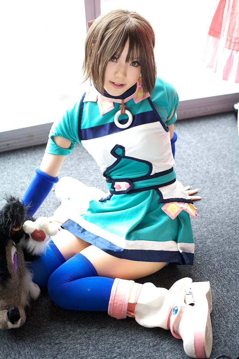 kipi-san, branky, mel, gensou suikoden, gensou suikoden iii, highres, photo (medium), 1girl, arm support, asian, blue gloves, blue thighhighs, breasts, brown eyes, brown hair, cosplay, elbow gloves, fingerless gloves, gloves, indoors, looking at viewer, mel (cosplay), mole, puppet, short hair, sitting, small breasts, stuffed animal, stuffed toy, thighhighs, wariza, zettai ryouiki