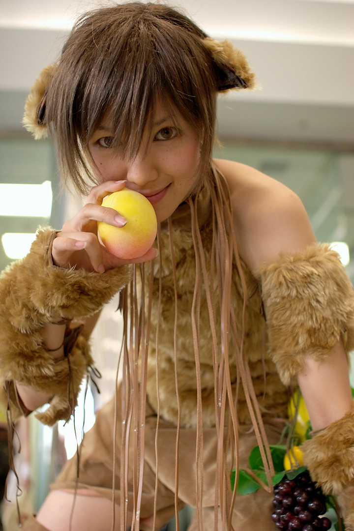 namako, tm revolution, wild rush, fur, photo (medium), 1girl, animal ears, asian, bare shoulders, blurry, brown eyes, brown hair, choker, cosplay, depth of field, dog ears, fake animal ears, food, fringe trim, fruit, grapes, indoors, leaf, leaning forward, looking at viewer, matching hair/eyes, mole, mole under eye, peach, short hair, smile, solo focus, thighhighs