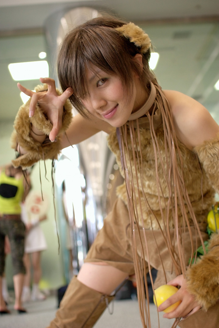namako, tm revolution, wild rush, fur, photo (medium), 1girl, animal collar, animal ears, asian, bare shoulders, blurry, brown eyes, brown hair, choker, collar, cosplay, depth of field, dog ears, fake animal ears, food, fringe trim, fruit, indoors, looking at viewer, matching hair/eyes, one eye closed, peach, short hair, smile, solo focus, thighhighs, wink