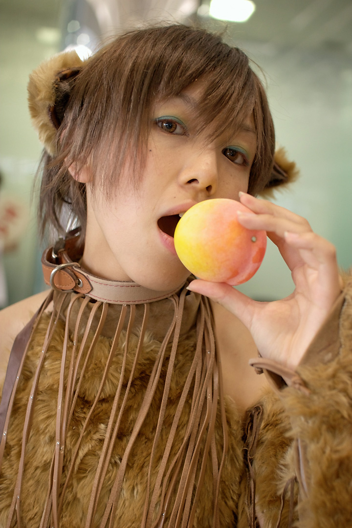 namako, tm revolution, wild rush, fur, photo (medium), 1girl, animal collar, animal ears, asian, bare shoulders, blurry, brown eyes, brown hair, choker, collar, cosplay, depth of field, dog ears, eyeshadow, fake animal ears, female focus, food, fringe trim, fruit, indoors, makeup, matching hair/eyes, peach, short hair, solo