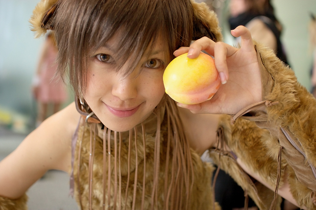 namako, tm revolution, wild rush, fur, photo (medium), 1girl, animal collar, animal ears, asian, bare shoulders, blurry, brown eyes, brown hair, choker, collar, cosplay, depth of field, dog ears, fake animal ears, female focus, food, fringe trim, fruit, indoors, looking at viewer, matching hair/eyes, mole, peach, short hair, smile, solo