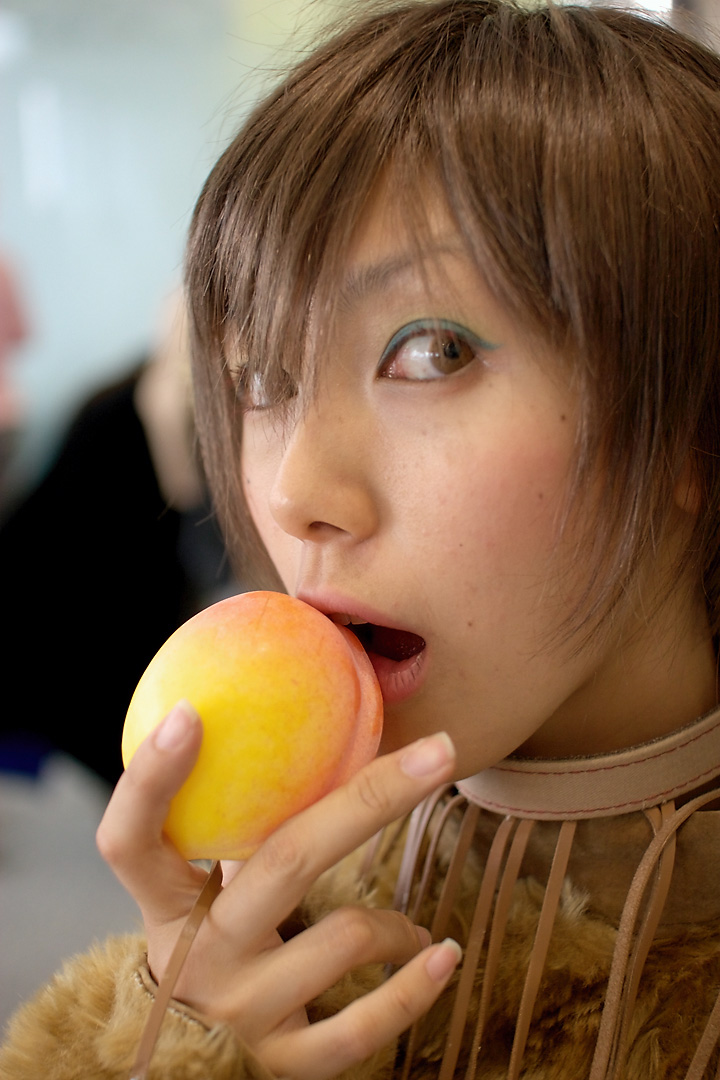 namako, tm revolution, wild rush, fur, photo (medium), 1girl, animal collar, animal ears, asian, blurry, brown eyes, brown hair, choker, collar, cosplay, depth of field, dog ears, eyeshadow, female focus, food, fringe trim, fruit, indoors, looking at viewer, makeup, matching hair/eyes, peach, short hair, solo